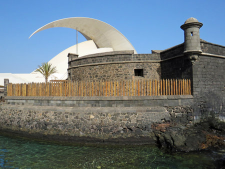 Santa Cruz de Tenerife, February, 2022: The Black Castle. Defensive Coastal Tower made of basalt stone, with two vigil squares and a Modern Concert Hall profile. Architecture and Construction patternのeditorial素材