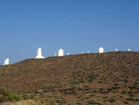 Profile of white telescopes under blue sky. Teide Astrophysical Observatory. Observational set of the Institute of Astrophysics. Architecture pattern. Universe, research concept.の写真素材