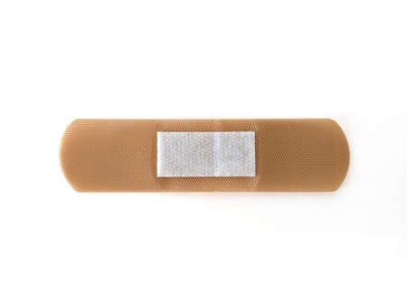 Aerial view of Medical patch, adhesive bandage in horizontal position isolated on white background. Protective tape strip, wound patch close up. First aid adhesive plaster. Sanitary concept.の写真素材