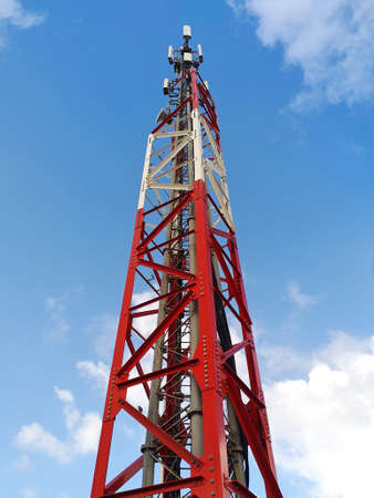 Bottom view of telecommunications tower under Caribbean blue sky. Metallic structure and antennas...