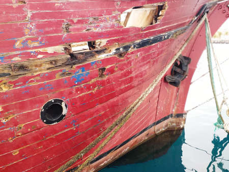 Bow and hull of Old abandoned wooden traditional fishing boat. Ancient Rusty Ship Board of old and...