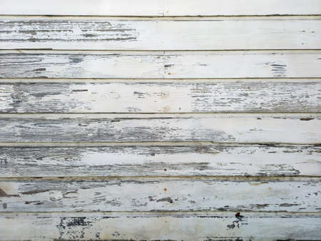 Background of horizontal old white wood slats. Old and weathered white sheets background. Architecture and construction of the French Antilles. Creole style.の写真素材