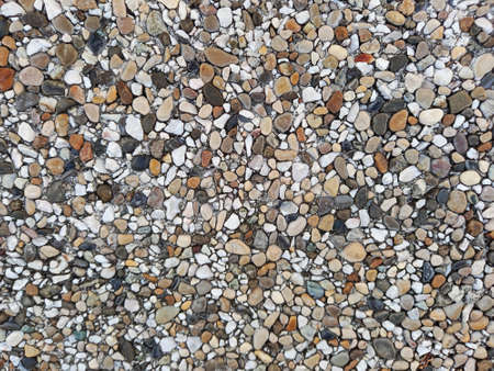 Background of sea stones of different shapes and tones. Small Naturally Polished Rocks, Pebbles...