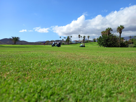 July 23, 2022; Tenerife: Panoramic view of golf course with carts under blue sky in Tenerife, Canary Islands. Golf course overview.のeditorial素材