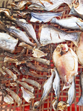 Full frame of fish drying. Aerial view of different fish drying in the sun on a grill. Asian and Oriental Food and Gastronomy. Street food concept.の写真素材