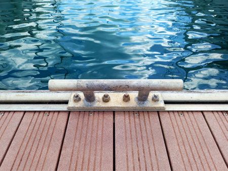 Close up of Rusty Mooring Bollard and Turquoise Water. Boat mooring structure. Dock mooring cleat. Old rusty steel mooring bollard pole on a pier. French West Indies.の写真素材