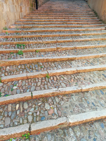 Perspective view of cobblestone and stone staircase. Pavement stone steps texture. Granite cobblestone floor. Architecture and Constructions. Full frame brick structure.の素材