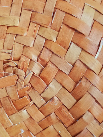 Straw texture detail. Woven bamboo background. Handmade full frame of raffia fabric.の素材