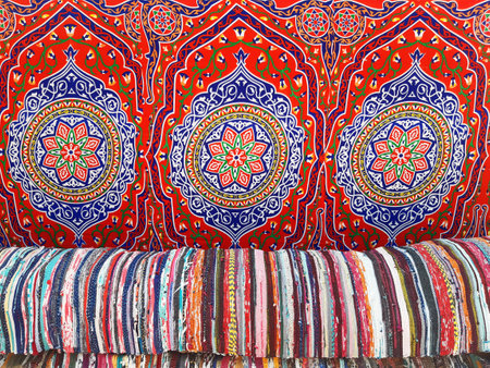 Background of various handmade cotton arabic fabrics. Chill out. Colorful wool Bedouin blankets. Arabic decoration and culture.の素材