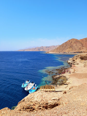 Panoramic view of the Red Sea coast with fishing boat and Desert mountain. Extreme landscapes.の写真素材