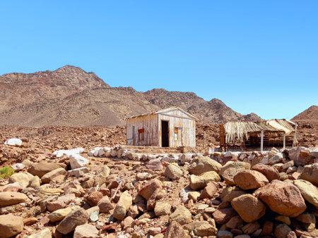 Abandoned cabins in a desert area of the Sinai Peninsula. Destroyed Bedouin hut between rocks. Constructions and Architecture of the desert. Extreme landscapes and living conditions.の写真素材