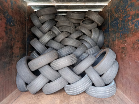 Stacked tires. Pile of old wheels piled up in container. Recycling and environment. Workshops and vehicle spare parts.の写真素材