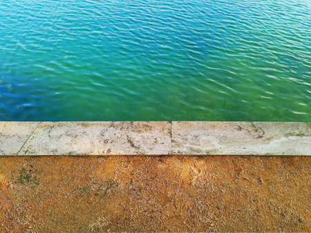 Edge of lake with green water.の写真素材