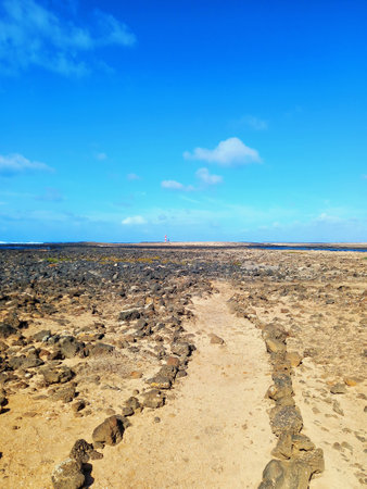 Dirt road in desert landscape under blue sky. Nature and extreme sports.