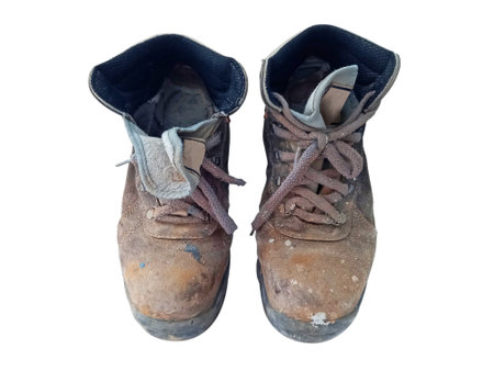 Top view of old work boots. Close-up of professional shoes isolated. Pair of dirty painter's shoes on a white background.の写真素材