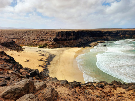 Cliffs on the beach. Extreme landscape of a cliffed coast, and blue sky. Coastal background.の写真素材