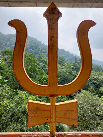 Golden trident or trishula of Shiva at a temple in the holy city of Rishikesh. Spectacular...