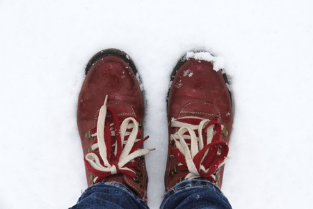 Red boots in the snow. Winter has come.の写真素材