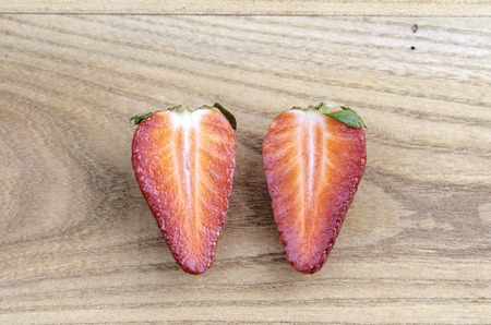 One strawberry cut in halfの写真素材