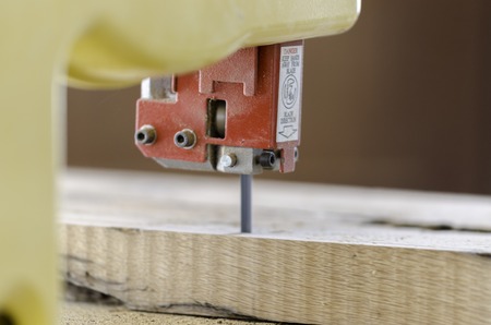 A carpenter works on woodworking the machine tool.