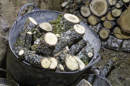 Firewood on black plastic basketの写真素材