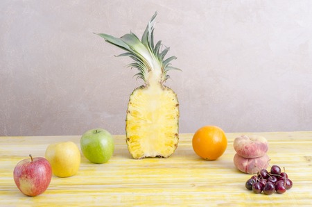 Organic Fruits over yellow Wood background, horizontal.の写真素材