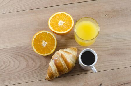 Breakfast cup of coffee, croissant and orange juice.の写真素材