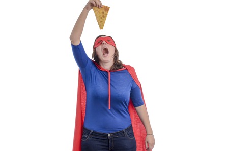 Woman superhero eating a piece of pizza with a red cape, white background