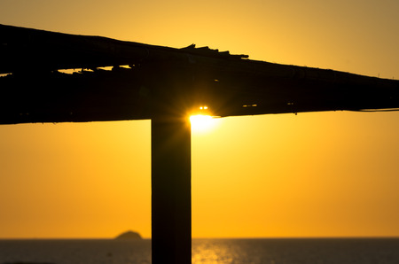 Beautiful sunset in Cala conta in Ibiza, Spain. Silhouette of beach bar.の写真素材