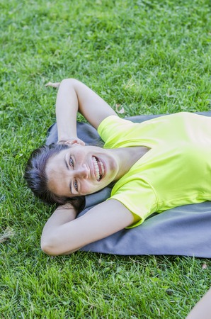 Girl is happy doing exercise in a park.の写真素材