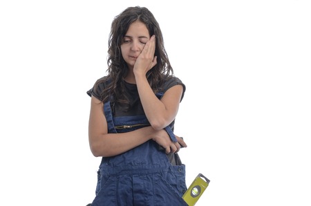 Worker woman worried by the job over white background.の写真素材