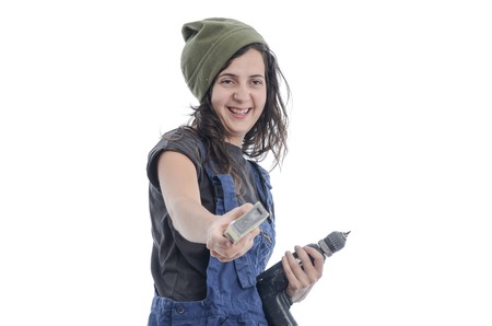 Worker woman with overalls and drill over white background. Very happy.の写真素材