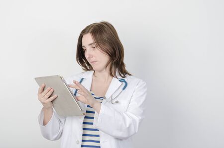 Female doctor holding a tablet computer with phonendoscope.の写真素材