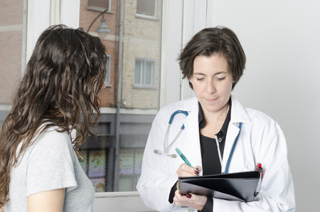 Female patient and doctor in examination room.の写真素材
