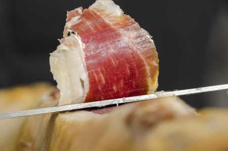 Cutting iberian spanish ham, bellota ham. Gourmet spanish food.の写真素材