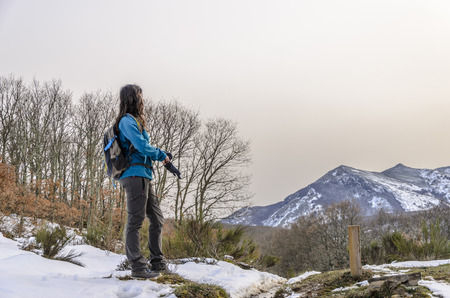 Woman trekking in winter mountains in Montaña Palentina, Spain.の写真素材