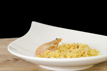 Paella with seafood, typical Spanish dish on white background.の写真素材