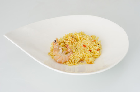 Paella with seafood, typical Spanish dish on white background.の写真素材