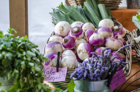 Fresh organic turnip on a basket at market and more vegetables.の写真素材