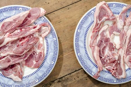 High Angle Close Up View of Raw Lamb Fillets on old Wooden.の写真素材