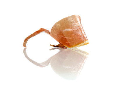 Slice of cured iberian ham, bellota ham, serrano with reflections over white background. Gourmet spanish food.の写真素材