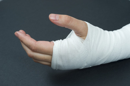 Hand tied elastic bandage on a black background.の写真素材