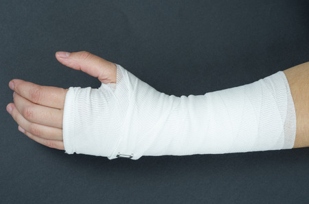 Hand tied elastic bandage on a black background.の写真素材