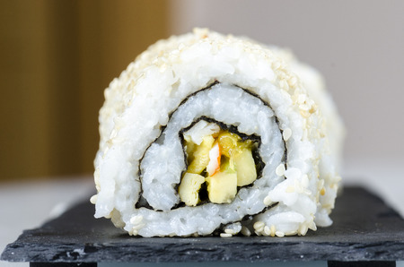 Sushi, california roll with sesame seeds on a slate plate.の写真素材