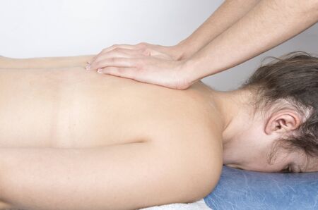 Physiotherapist, chiropractor giving a massage to a patient.