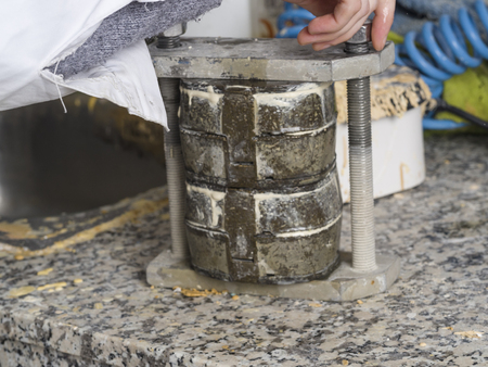 Dental technician is working with a dental flask of a complete upper on cast.の写真素材