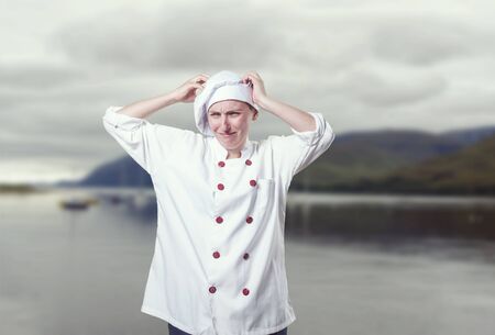 Young woman chef overwhelmed, she has a lot of probems.の写真素材