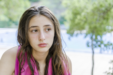 Beautiful teenager relaxed on her holidays, after bathing in the pool.の写真素材