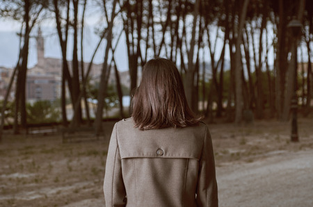 Woman with his back turned with a coat outdoors.の写真素材