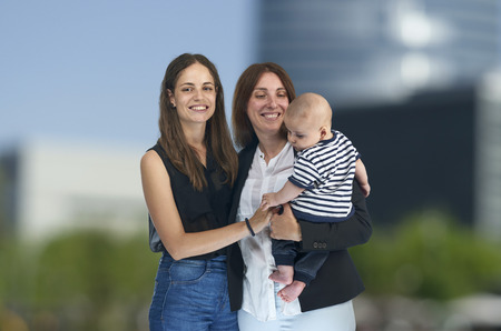Lesbian love, young lesbian mothers with their baby. Homosexual familyの写真素材